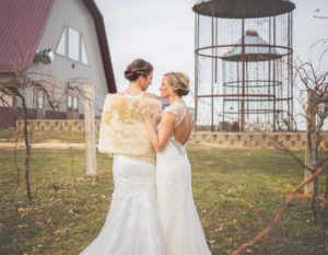 Beautiful brides outside the barn at Pedretti's Party Barn in Viroqua, Wisconsin
