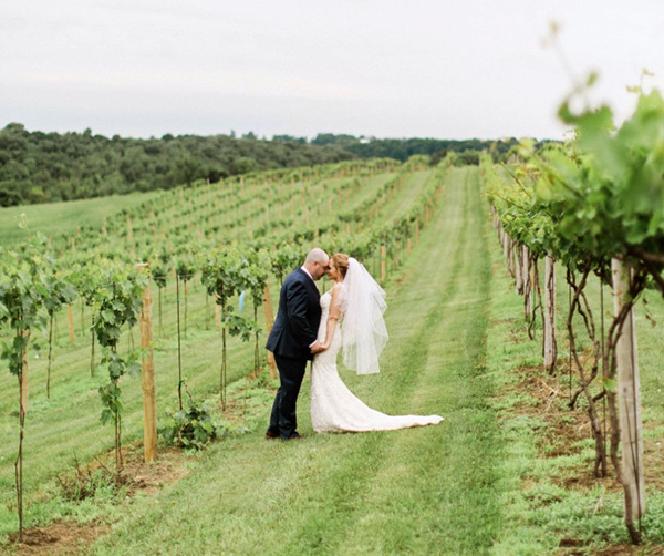 Bride and groom standing in the vineyard at Pedretti's Party Barn in Viroqua, Wisconsin