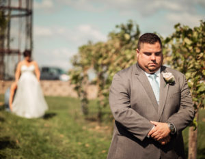 Bride and groom share first look in the vineyard at Pedretti's Party Barn in Viroqua, Wisconsin