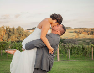 Groom and bride dancing and kissing in the vineyard at Pedretti's Party Barn in Viroqua, Wisconsin
