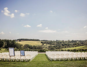 Summer ceremony setup overlooking the vineyard at Pedretti's Party Barn in Viroqua, Wisconsin