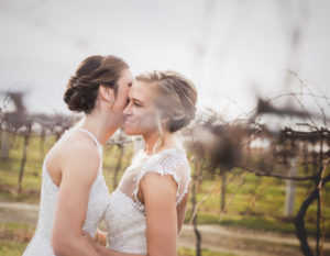 Brides in the vineyard for fall wedding photos at Pedretti's Party Barn in Viroqua, Wisconsin