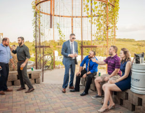 Guests enjoy cocktail hour on paved patio at Pedretti's Party Barn in Viroqua, Wisconsin